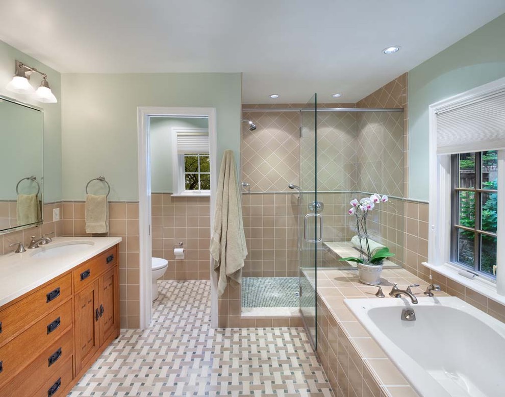 This is an example of a traditional bathroom in DC Metro with mosaic tile and an enclosed toilet.