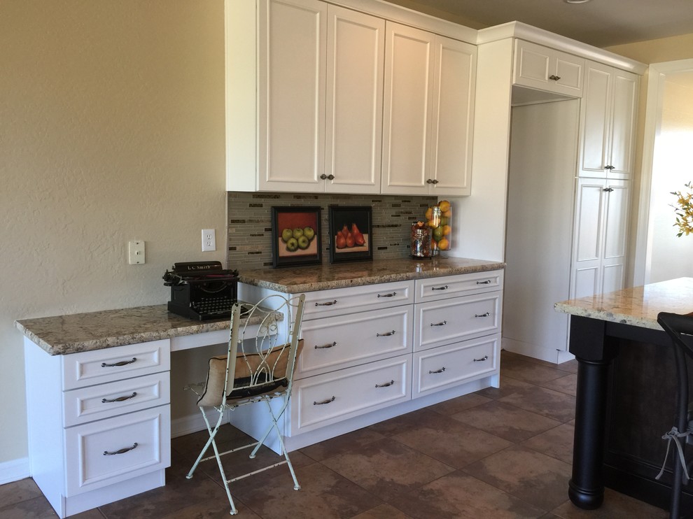 Inspiration for a large transitional eat-in kitchen remodel in Phoenix with granite countertops, gray backsplash, stone tile backsplash, black appliances and an island