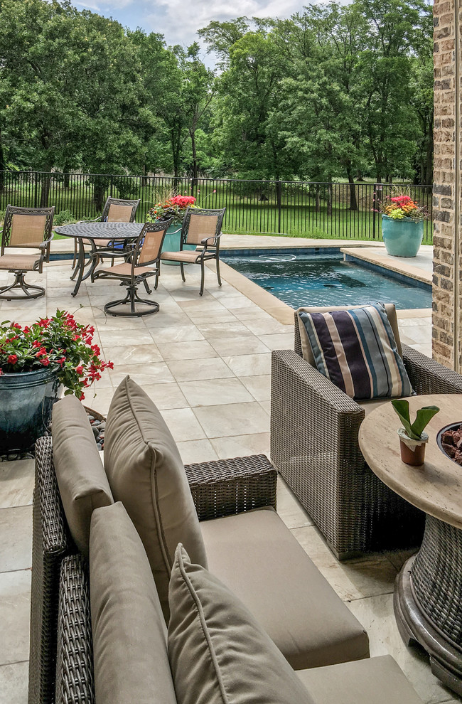 This is an example of a small traditional backyard rectangular pool in Dallas with tile.