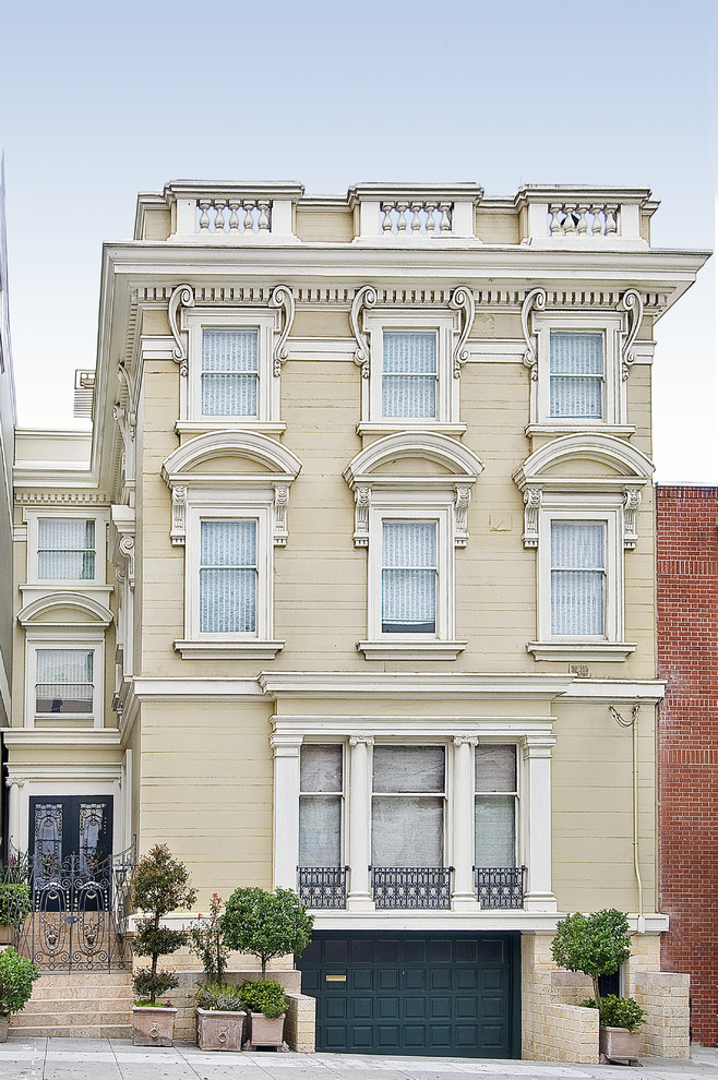 Photo of a large traditional three-storey beige exterior in San Francisco.