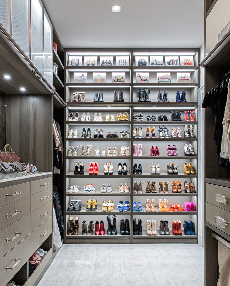 Inspiration for a large contemporary women's walk-in wardrobe in New York with open cabinets, carpet and grey floor.