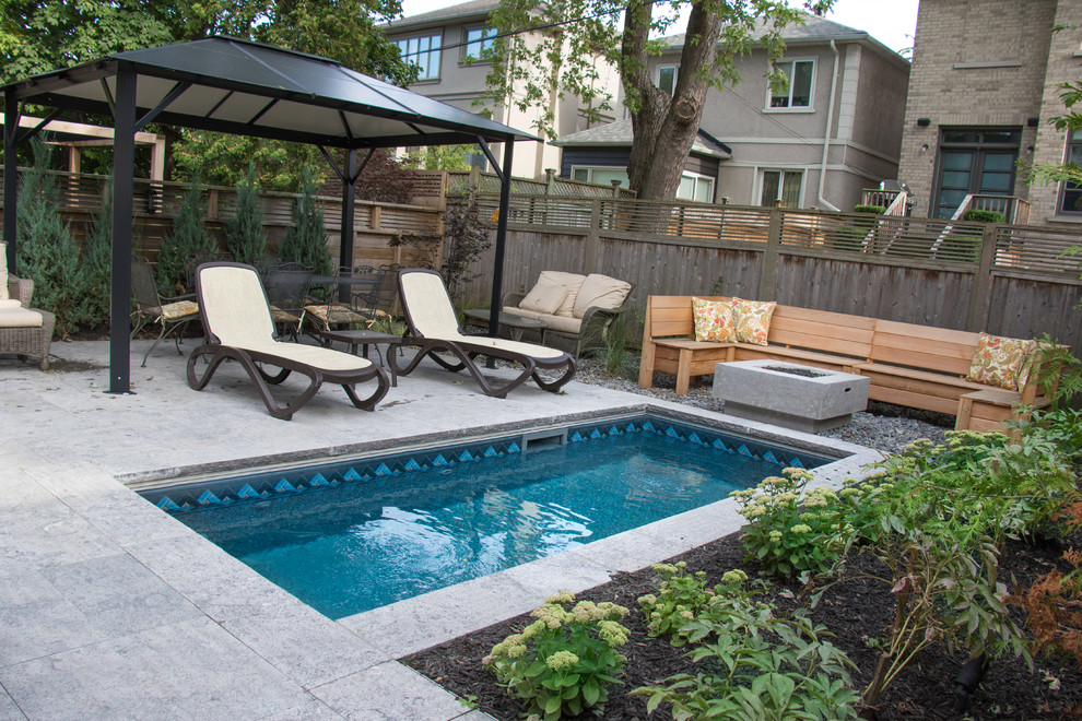 Inspiration for a small transitional backyard garden in Toronto with a fire feature.