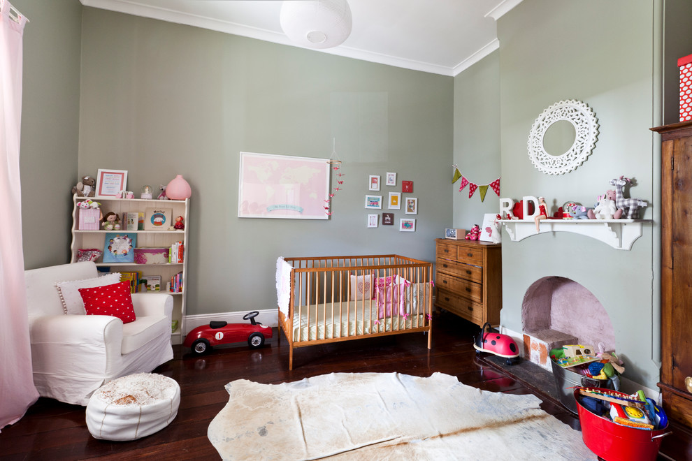 Large eclectic gender-neutral nursery in Perth with grey walls, dark hardwood floors and brown floor.