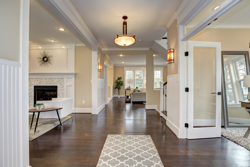 Design ideas for an expansive arts and crafts foyer in DC Metro with beige walls, dark hardwood floors, a single front door and a medium wood front door.