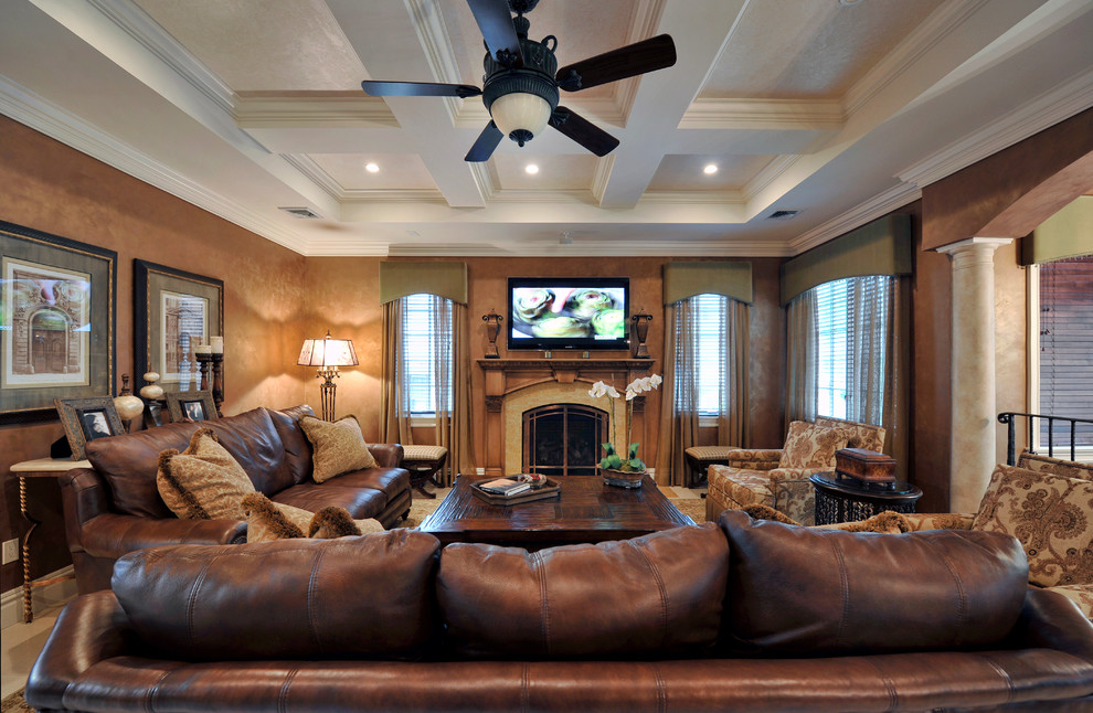 Photo of a large mediterranean family room in New York with brown walls, dark hardwood floors, a standard fireplace, a stone fireplace surround and a wall-mounted tv.