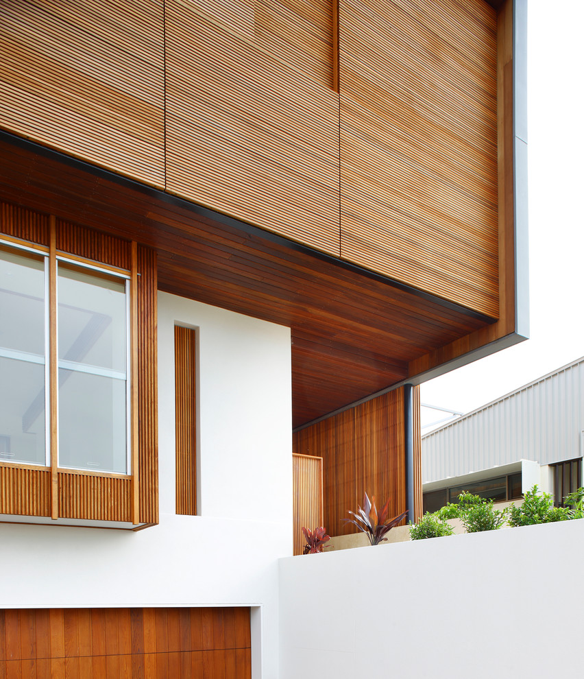 Large contemporary two-storey exterior in Brisbane with wood siding.