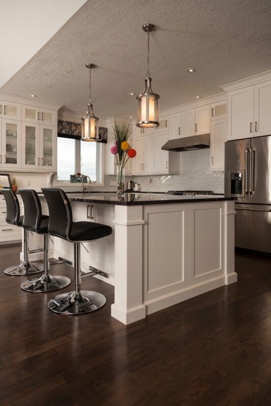 Open concept kitchen - transitional l-shaped dark wood floor open concept kitchen idea in Toronto with an undermount sink, shaker cabinets, white cabinets, marble countertops, blue backsplash, glass tile backsplash, stainless steel appliances and an island