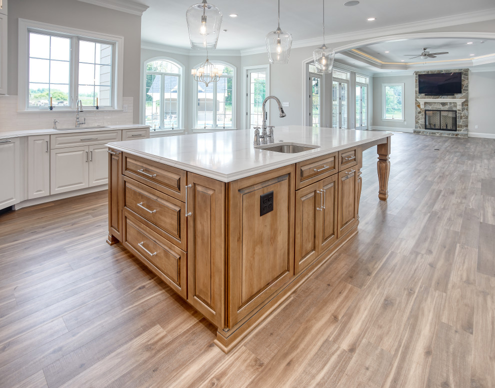 Transitional Kitchen with Two Toned Gathering Island & Archways