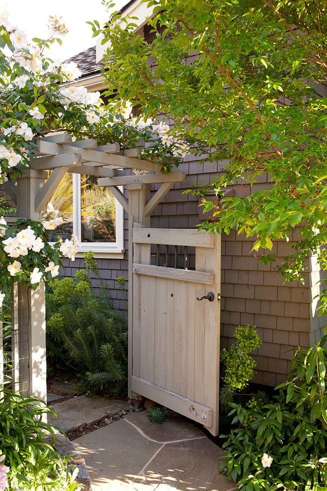 This is an example of a traditional partial sun garden in San Francisco with a garden path and natural stone pavers.