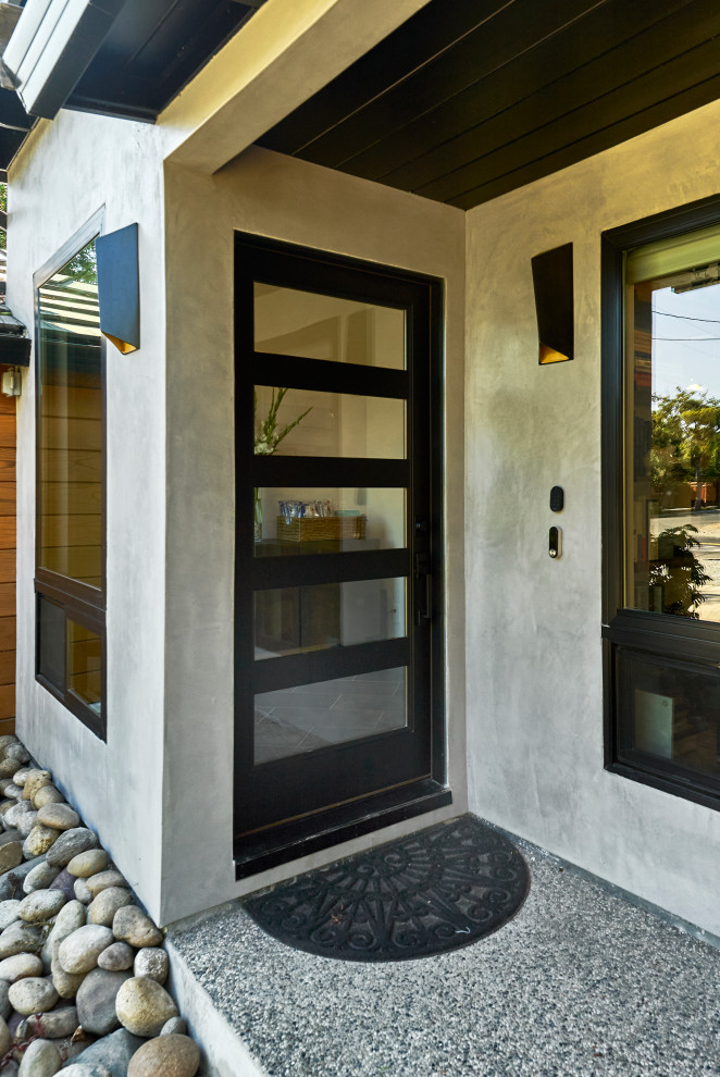 Inspiration for a mid-sized 1960s gray one-story stucco house exterior remodel in San Francisco with a gray roof