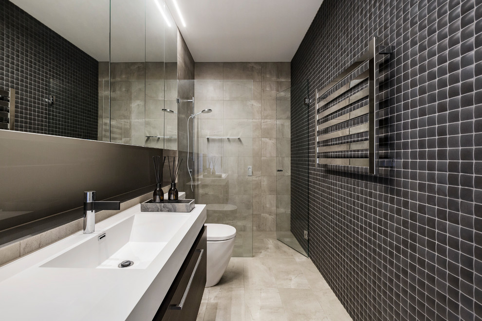 Inspiration for a contemporary 3/4 bathroom in Melbourne with flat-panel cabinets, black cabinets, an alcove shower, beige tile, black tile, grey walls, an integrated sink, beige floor, a hinged shower door and white benchtops.