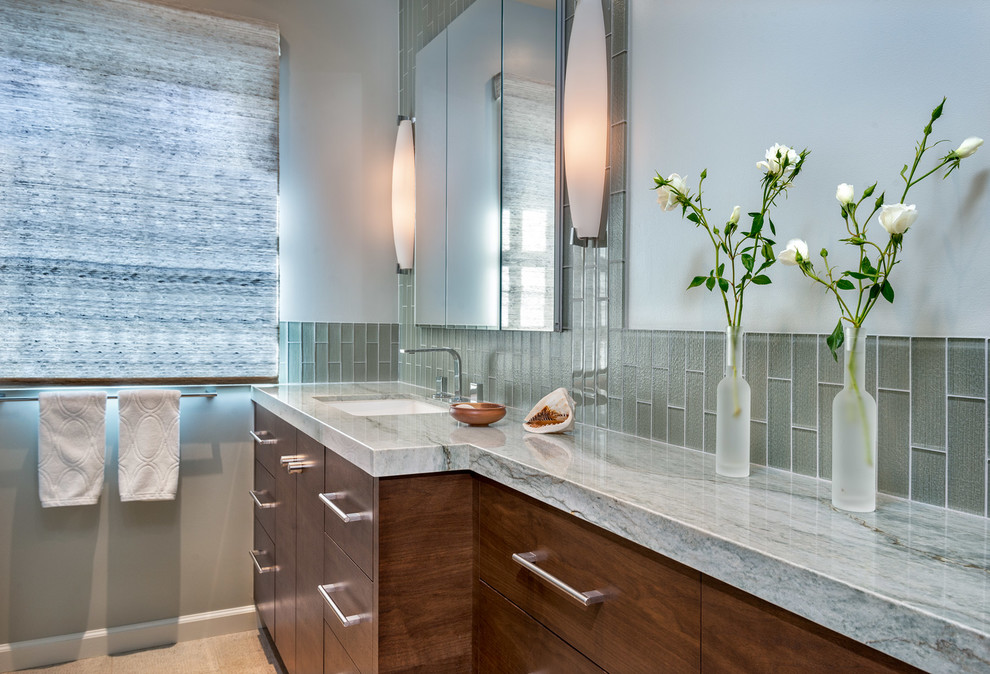 Photo of a mid-sized contemporary bathroom in San Francisco with flat-panel cabinets, medium wood cabinets, green tile, glass tile, white walls, an undermount sink, quartzite benchtops and beige floor.