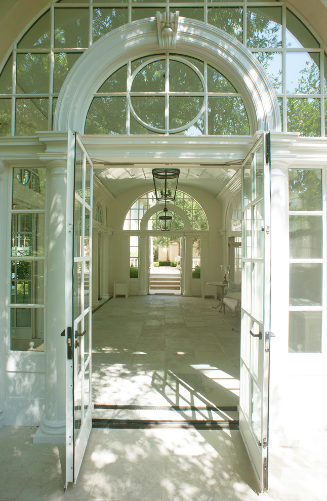 This is an example of a large mediterranean foyer in Dallas with white walls, ceramic floors and grey floor.