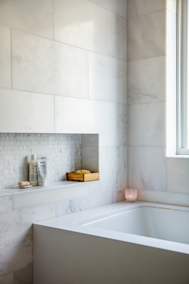 Mid-sized minimalist master white tile and stone tile marble floor and white floor bathroom photo in San Francisco with furniture-like cabinets, medium tone wood cabinets, an undermount tub, a one-piece toilet, white walls, an integrated sink, quartz countertops and white countertops