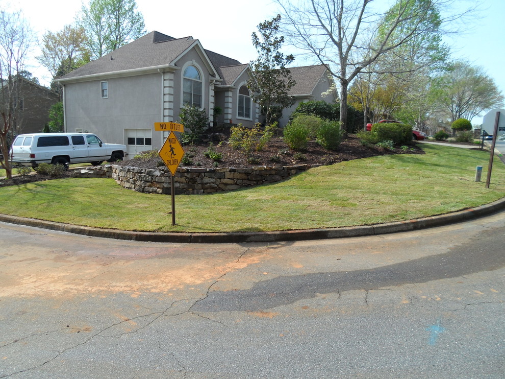 Photo of a large traditional side yard full sun xeriscape in Atlanta with a retaining wall.