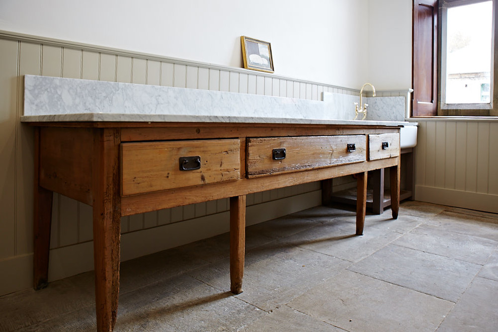 Inspiration for an expansive retro open plan kitchen with a belfast sink, shaker cabinets, red cabinets, wood worktops, ceramic flooring, an island and black floors.