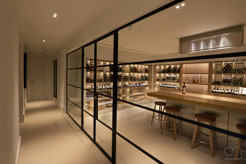 Design ideas for a large contemporary wine cellar in London with limestone floors, display racks and white floor.