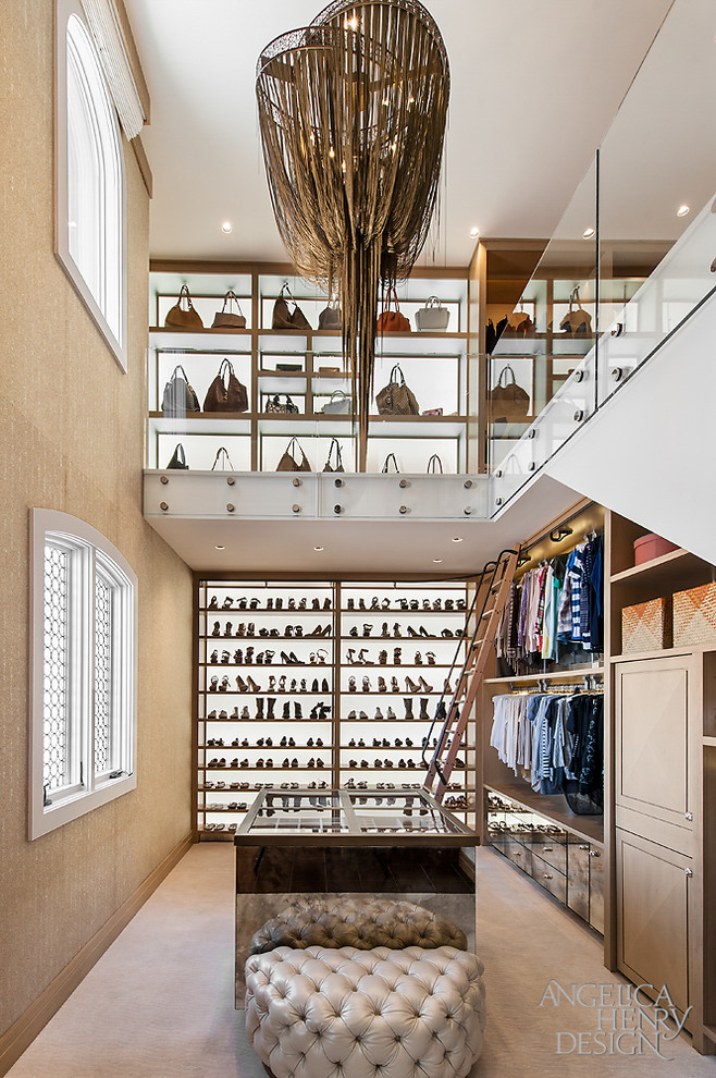 Example of a mountain style women's carpeted walk-in closet design in Phoenix with open cabinets