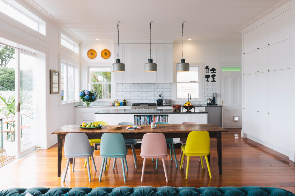 Design ideas for a contemporary open plan dining in Auckland with white walls, medium hardwood floors and brown floor.