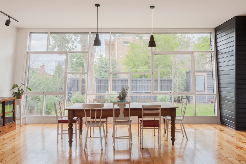 Design ideas for a mid-sized contemporary dining room in Melbourne with light hardwood floors.