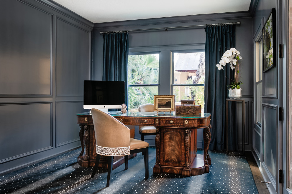 Traditional study room in Austin with grey walls, dark hardwood floors, a freestanding desk, blue floor and panelled walls.
