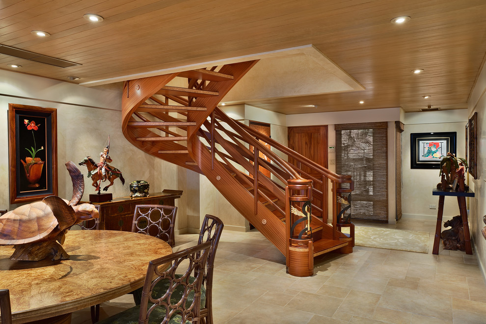 Inspiration for a large tropical wood curved staircase in Hawaii with open risers.