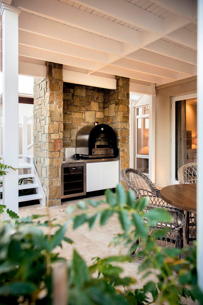 Inspiration for a beach style courtyard patio in Perth with an outdoor kitchen, brick pavers and a roof extension.