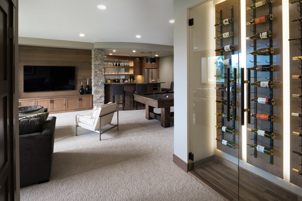 Inspiration for a mid-sized transitional look-out basement in Minneapolis with grey walls, carpet, a corner fireplace, a stone fireplace surround and beige floor.