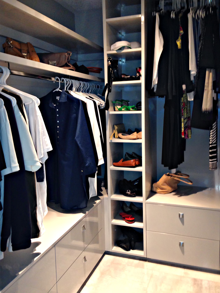 Inspiration for a small modern women's walk-in wardrobe in Toronto with flat-panel cabinets, grey cabinets and porcelain floors.
