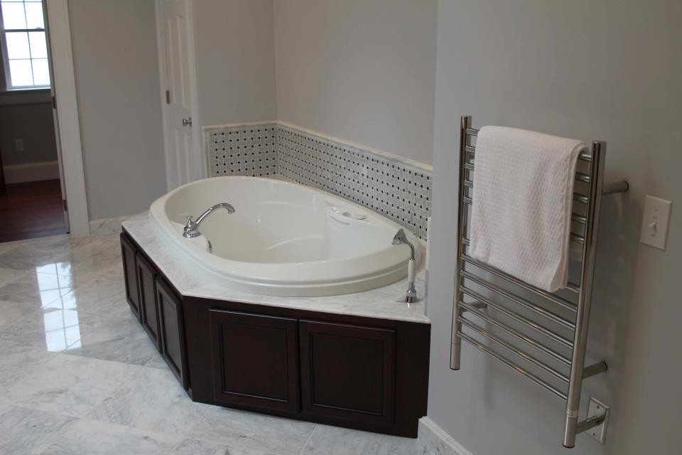 Transitional master gray tile and subway tile marble floor drop-in bathtub photo in Boston with recessed-panel cabinets, black cabinets, gray walls and granite countertops