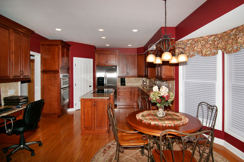 Inspiration for a mid-sized u-shaped dark wood floor eat-in kitchen remodel in Columbus with a double-bowl sink, recessed-panel cabinets, medium tone wood cabinets, granite countertops, beige backsplash, cement tile backsplash, stainless steel appliances and an island