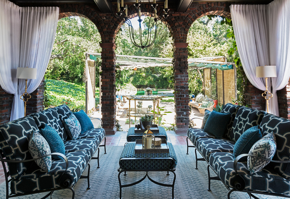 Photo of a traditional backyard patio in Los Angeles with a roof extension.