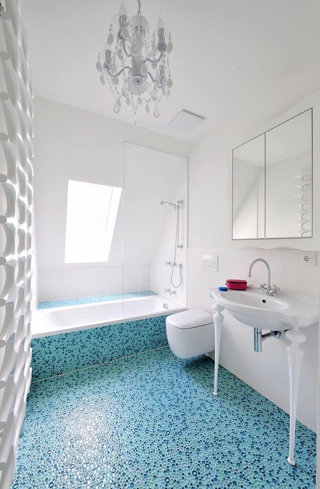 Photo of a mid-sized eclectic 3/4 bathroom in Munich with a drop-in tub, white walls, flat-panel cabinets, white cabinets, a curbless shower, a wall-mount toilet, white tile, porcelain tile, pebble tile floors, a trough sink, wood benchtops, beige floor and an open shower.