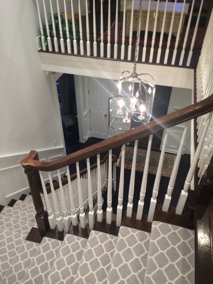 Large transitional carpeted l-shaped staircase in Chicago with carpet risers.
