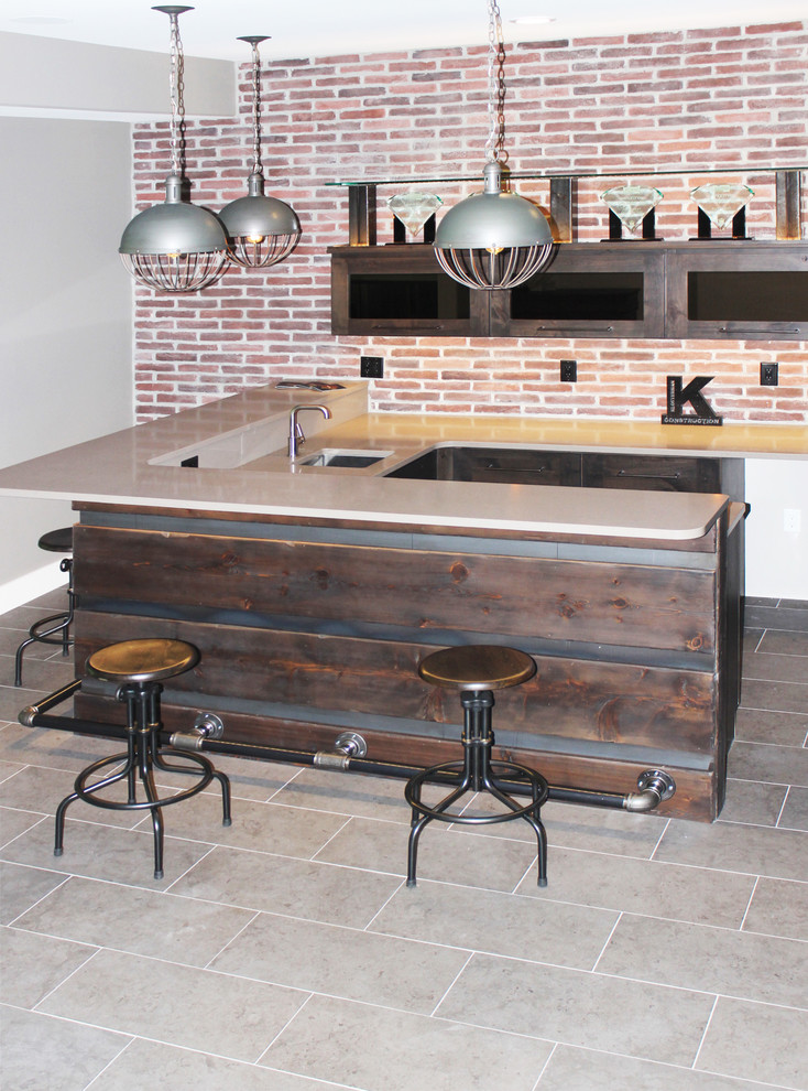 Design ideas for a mid-sized industrial u-shaped seated home bar in Cedar Rapids with an undermount sink, flat-panel cabinets, dark wood cabinets, quartzite benchtops, red splashback, brick splashback, ceramic floors, grey floor and beige benchtop.