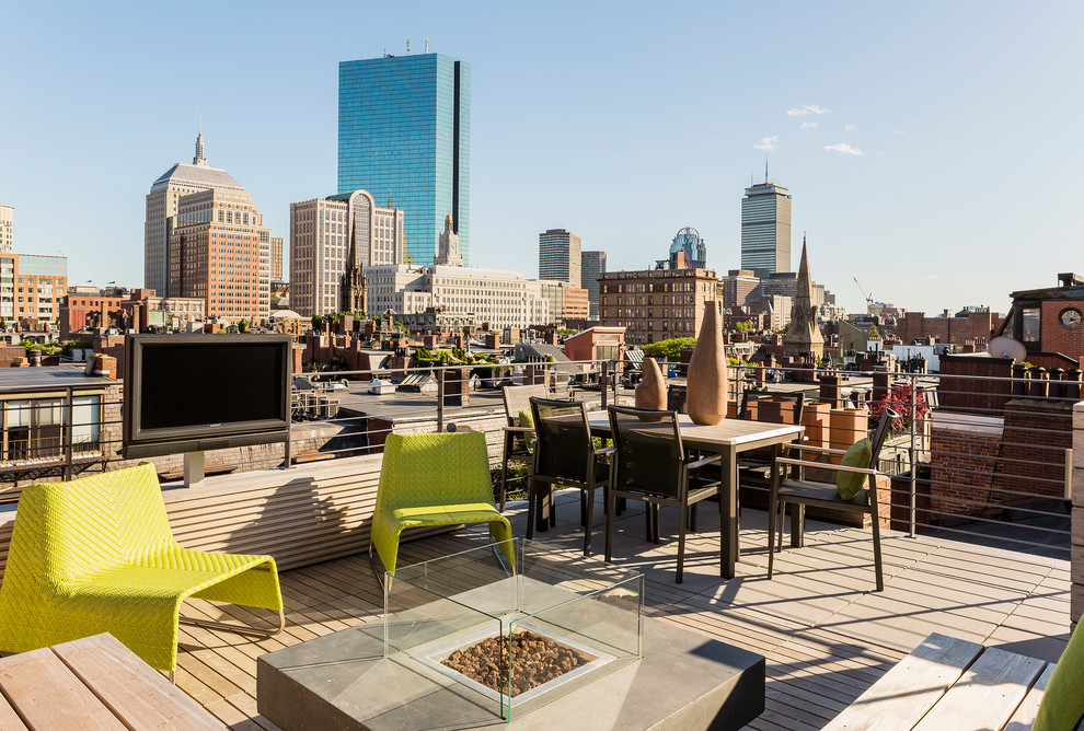 Modern rooftop deck in Boston with a fire feature and no cover.