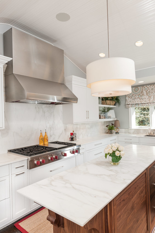 Design ideas for a traditional kitchen in Indianapolis with marble benchtops, white splashback, stone slab splashback, stainless steel appliances, an undermount sink and white cabinets.