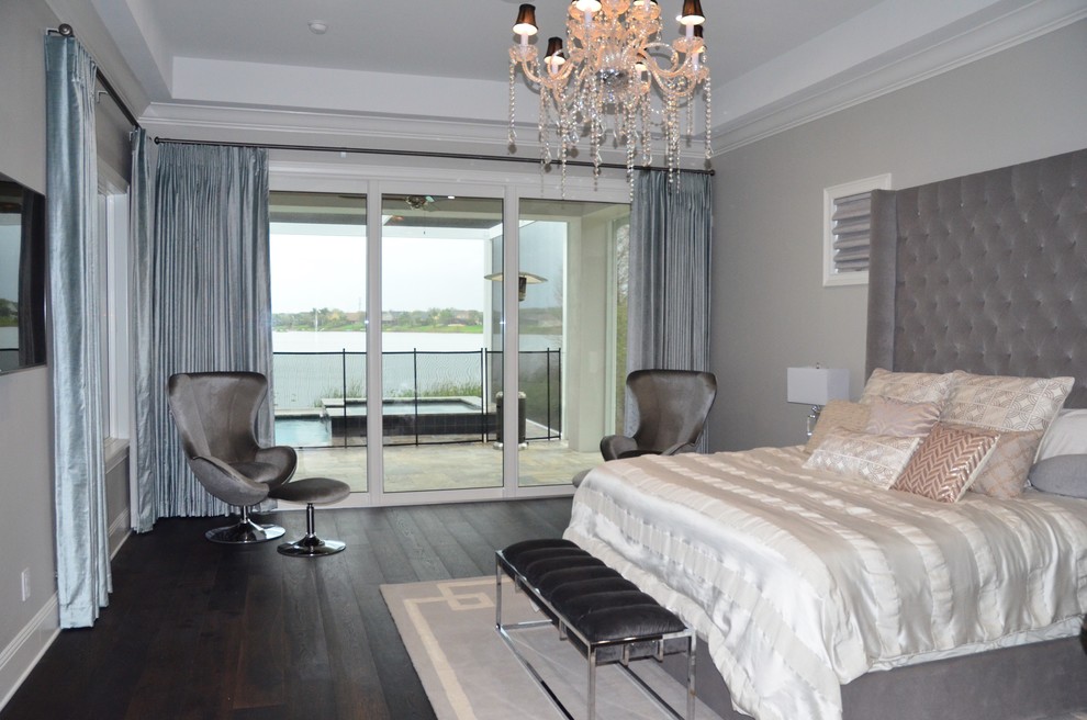 Photo of a large contemporary master bedroom in Orlando with grey walls and brown floor.
