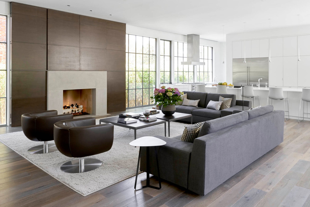 Photo of a large contemporary open concept family room in Dallas with white walls, dark hardwood floors, a standard fireplace and no tv.