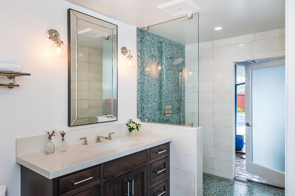 Design ideas for a mid-sized transitional master bathroom in San Francisco with flat-panel cabinets, dark wood cabinets, an alcove tub, an alcove shower, beige tile, porcelain tile, white walls, terrazzo floors, a trough sink, solid surface benchtops, blue floor and an open shower.