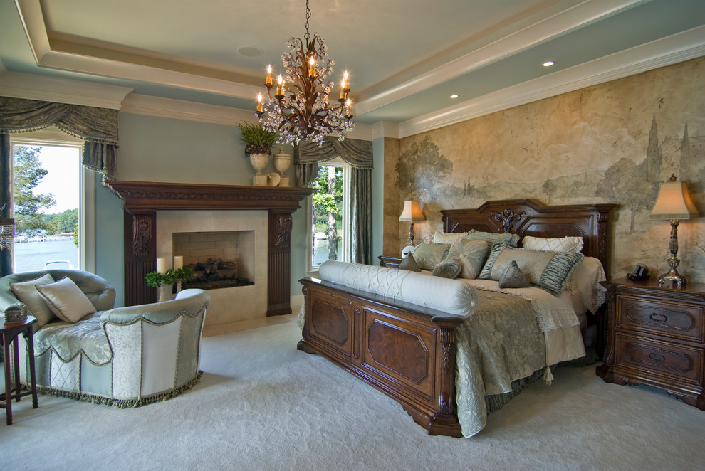 This is an example of a mediterranean bedroom in Charlotte with blue walls, carpet and a standard fireplace.