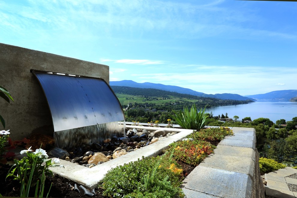 Inspiration for a mid-sized modern hillside concrete paver full sun home design remodel for spring in Vancouver