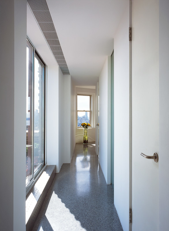 Photo of a modern hallway in New York with white walls, terrazzo floors and grey floor.
