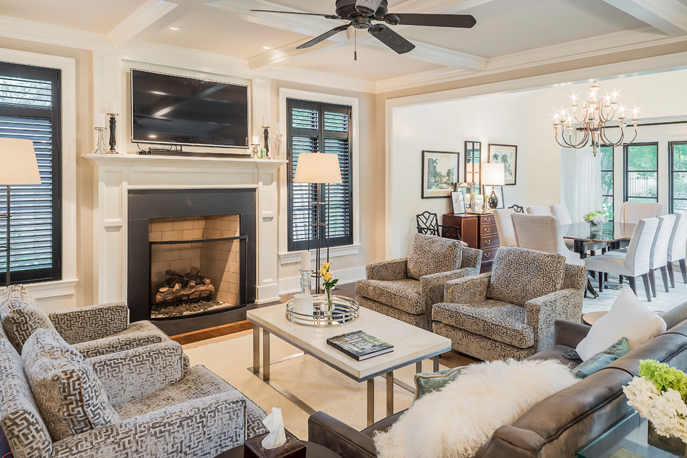 This is an example of a traditional formal open concept living room in Chicago with beige walls, dark hardwood floors, a standard fireplace, a metal fireplace surround, a wall-mounted tv and brown floor.