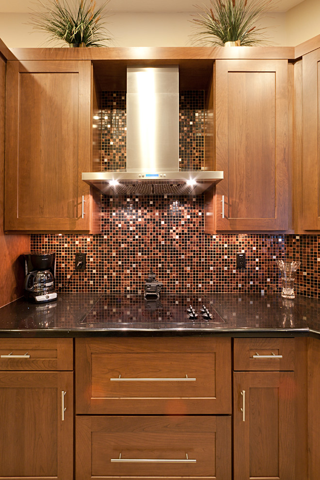Large transitional ceramic tile eat-in kitchen photo in Phoenix with an undermount sink, flat-panel cabinets, dark wood cabinets, quartz countertops, multicolored backsplash, mosaic tile backsplash, black appliances and no island