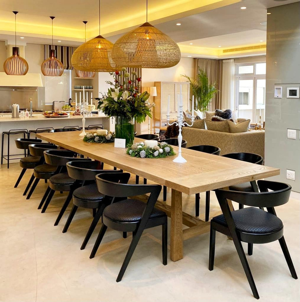 Photo of a large beach style dining room in London with white walls, no fireplace and beige floor.