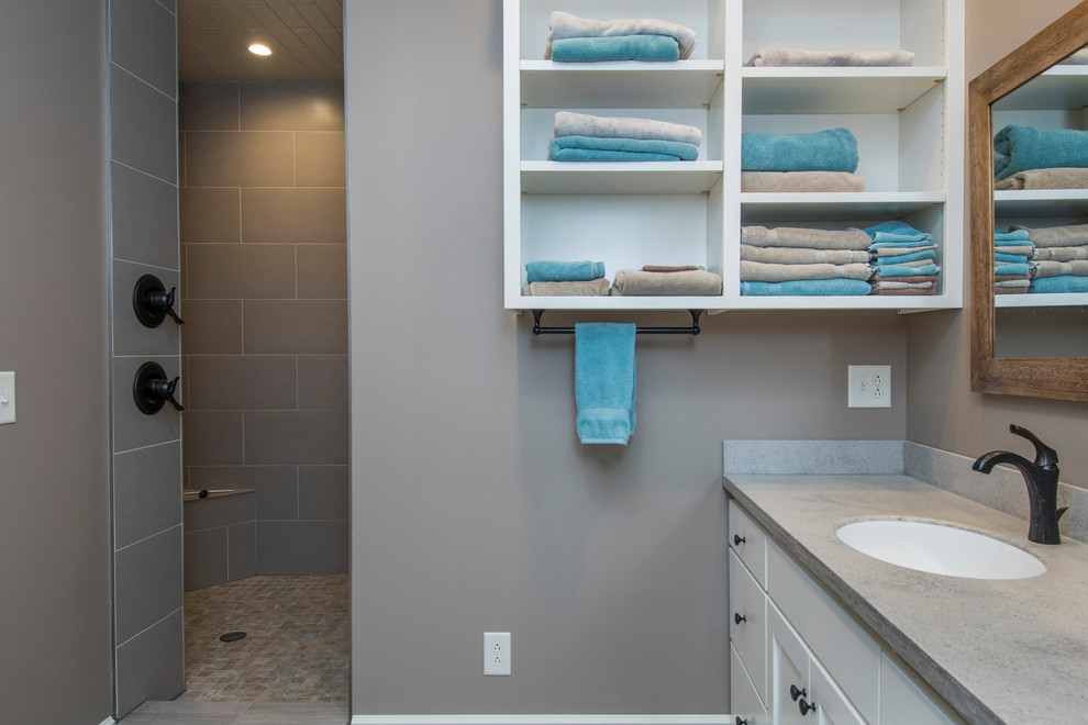 Doorless shower - large transitional 3/4 gray tile and porcelain tile dark wood floor and gray floor doorless shower idea in Columbus with shaker cabinets, white cabinets, a two-piece toilet, brown walls, an undermount sink and concrete countertops