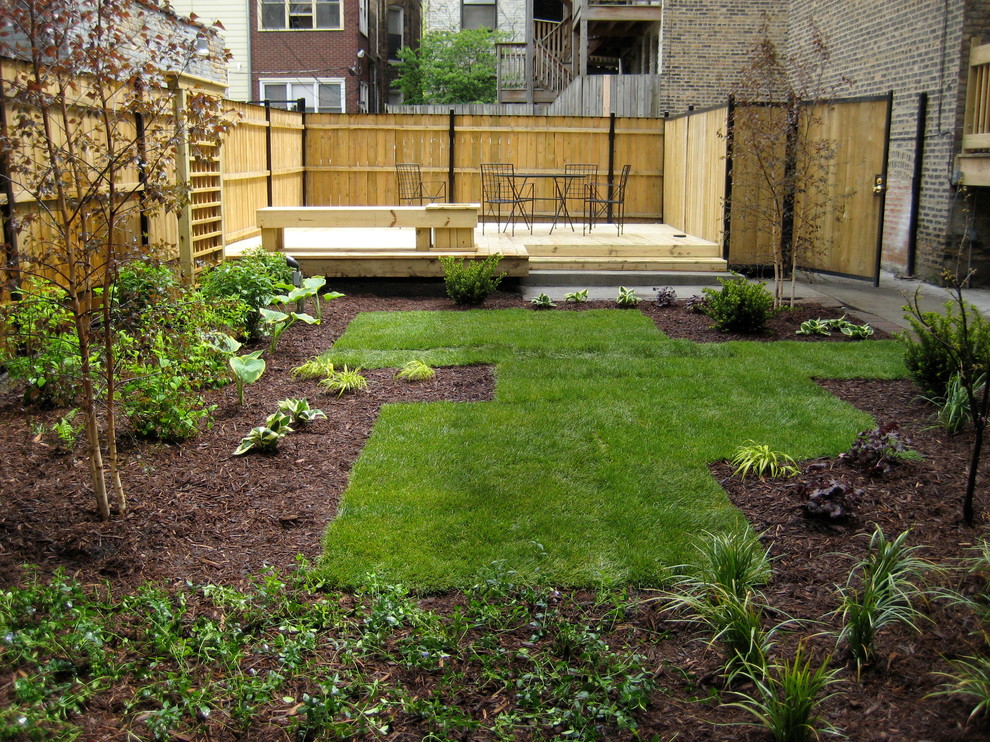 Photo of a small contemporary backyard full sun garden in Chicago with concrete pavers.