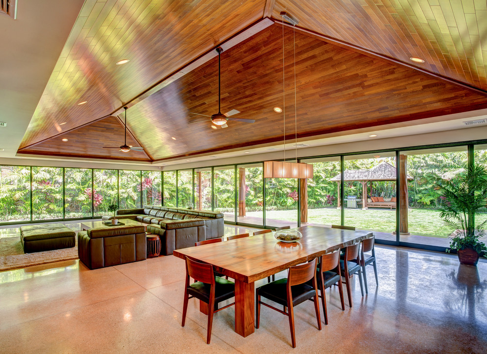 Contemporary open plan dining in Hawaii with concrete floors, no fireplace and grey floor.