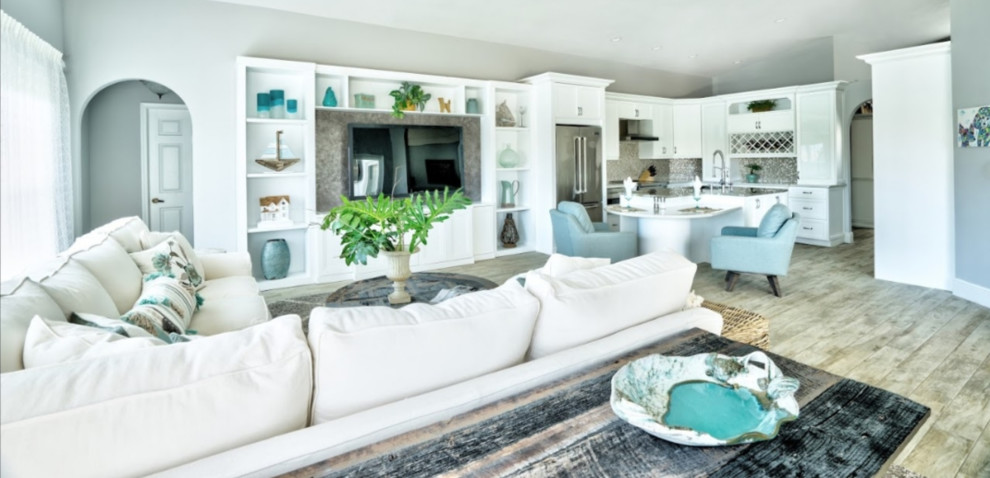 Inspiration for a large beach style open concept family room in Miami with grey walls, porcelain floors, a built-in media wall and beige floor.